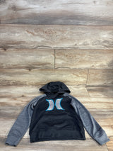 Flat lay of Hurley boys pullover hoodie size 5T, charcoal body with gray raglan sleeves and blue Hurley logo centered on chest on wooden floor