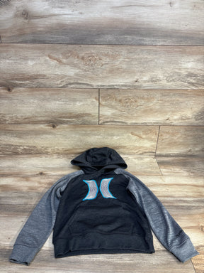 Flat lay of Hurley boys pullover hoodie size 5T, charcoal body with gray raglan sleeves and blue Hurley logo centered on chest on wooden floor