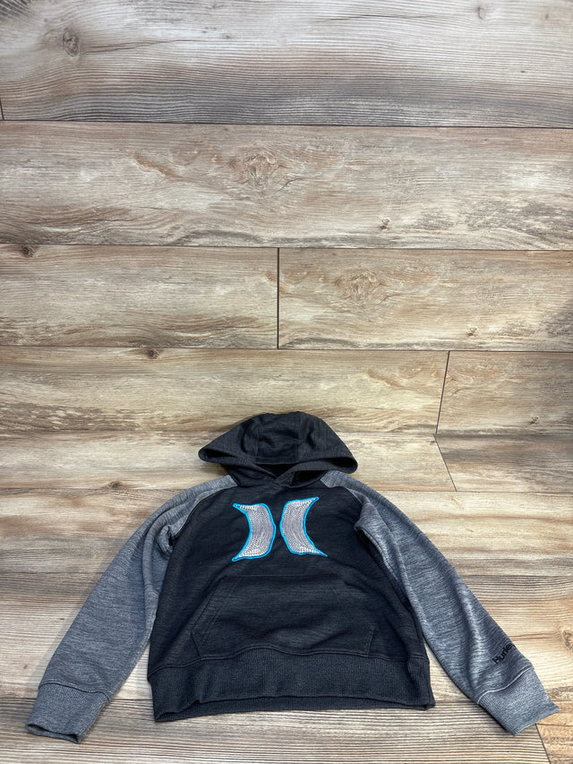 Flat lay of Hurley boys pullover hoodie size 5T, charcoal body with gray raglan sleeves and blue Hurley logo centered on chest on wooden floor