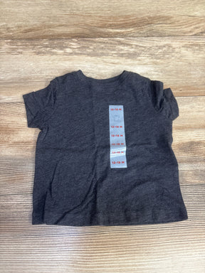 Dark gray baby t-shirt size 12-18 months on wooden surface