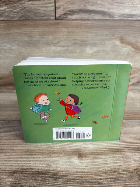 Back cover of a children's board book with green background, illustrations of two kids with backpacks, and text reviews