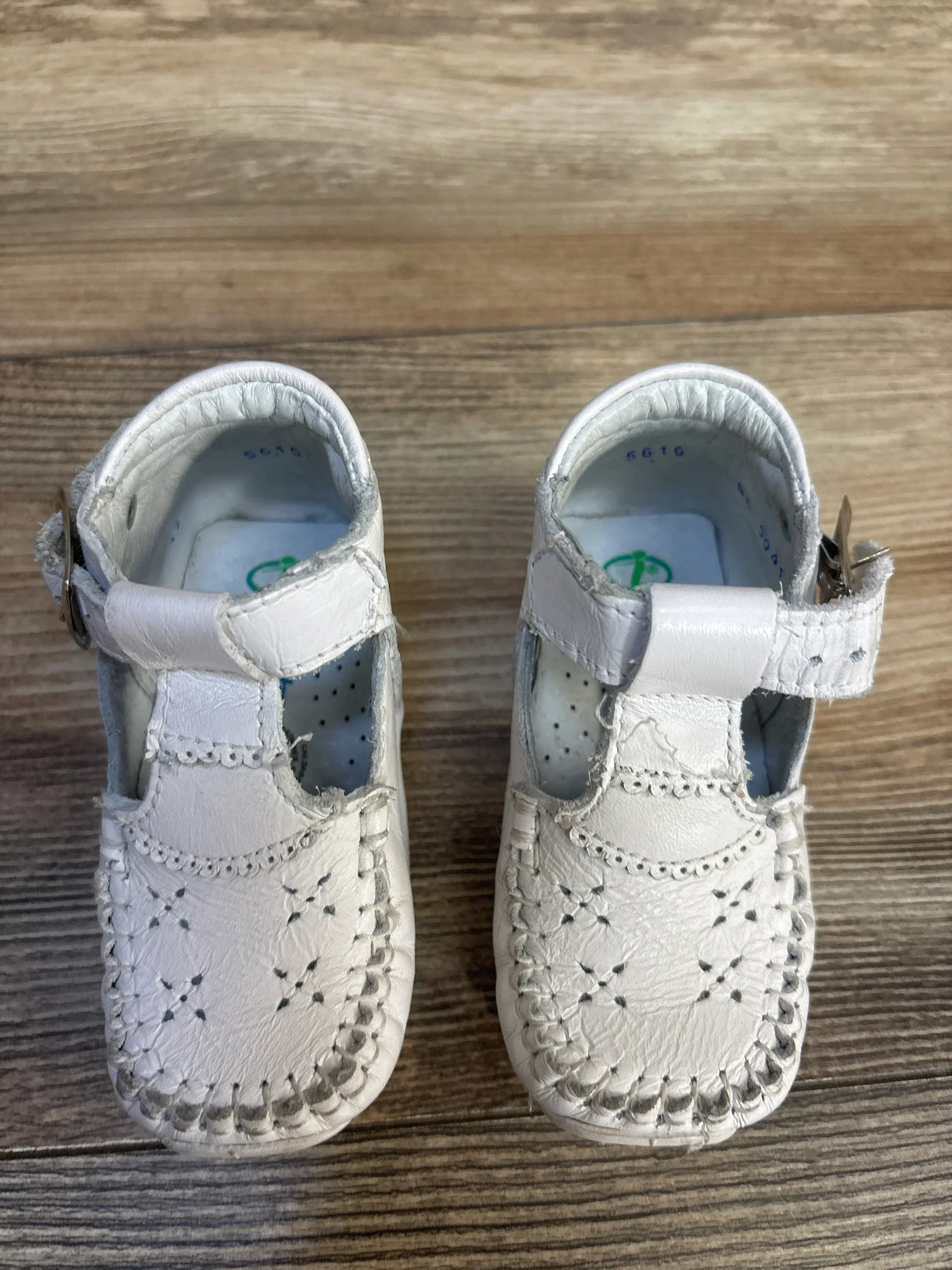 White baby girl Mary Jane shoes with lace trim, soft sole for infants, perfect for first steps and special occasions.