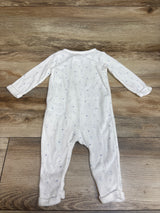 Front view of Child of Mine white sleeper in size 3 to 6 months, showcasing moon and star print and long sleeves on a wood background