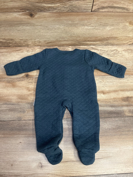Dark blue quilted long-sleeve baby onesie with feet laid flat on wooden floor