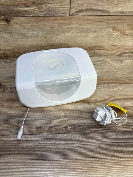 White baby wipe warmer with power cord on wooden surface