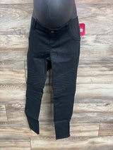 Front view of Isabel maternity utility jeggings in black showing ribbed knee panels, zip ankle hems and elastic belly panel on wood floor background