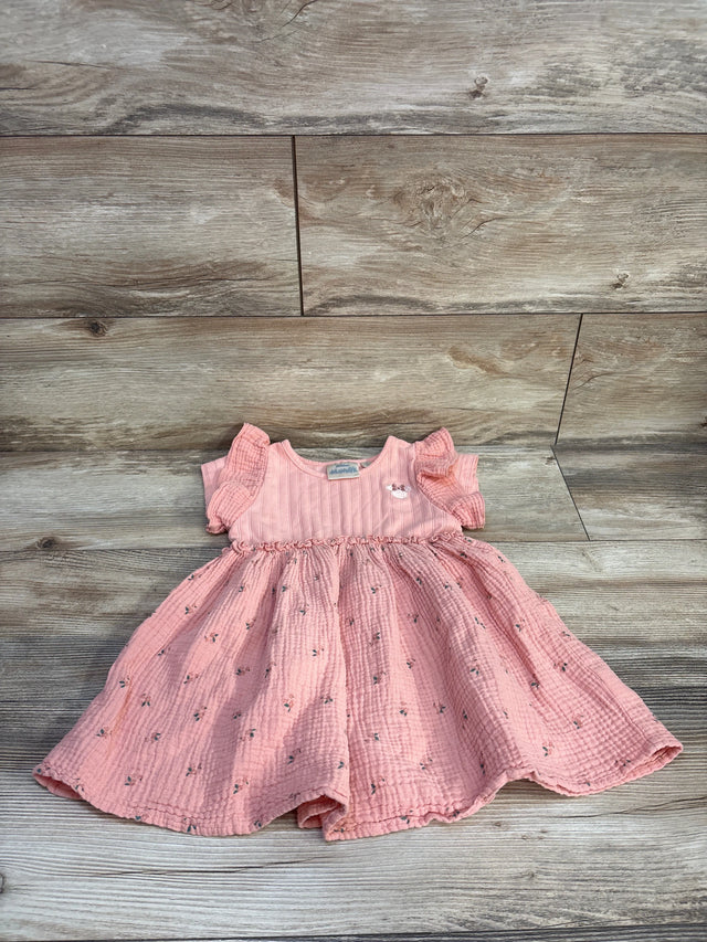 Top-down view of pink Disney Minnie muslin toddler dress size 3T showcasing flutter sleeves and floral skirt on wood