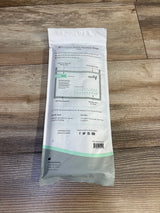 Top-down view of Motif microwave steam sterilizer bag (7-pack) showing back label with zipper-seal, pour spout diagram and usage markings on wood floor