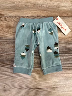 Blue fleece baby pants with tree print and Cat & Jack tag on wood background