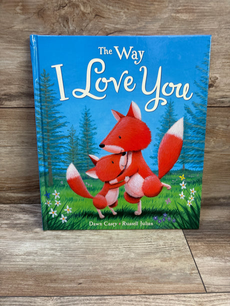 Front cover of The Way I Love You hardcover book showing two red foxes hugging beneath the title on blue sky and grass