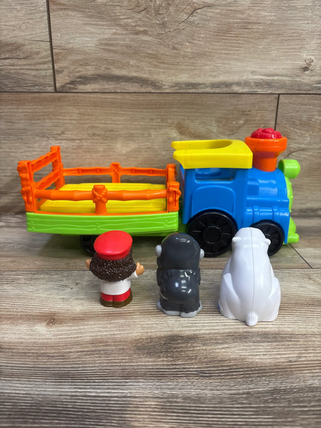Side view of Fisher-Price Choo Choo Zoo Train showcasing colorful locomotive, animal figures, and open wagon on wood flooring