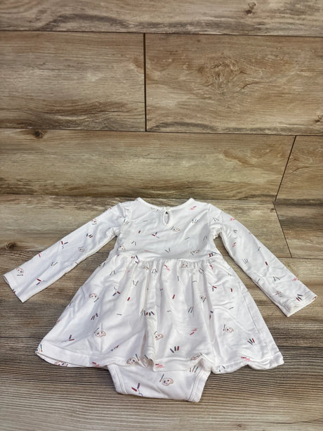 Top view of Carters PurelySoft Painters bodysuit dress in white with long sleeves and paint print on wood floor
