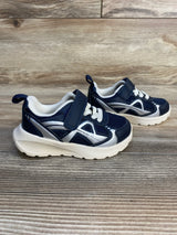 Navy blue and white toddler athletic sneakers with velcro strap on wood background