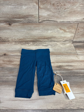 Blue Kickee kids pants with tags on wooden background, gently used children's clothing