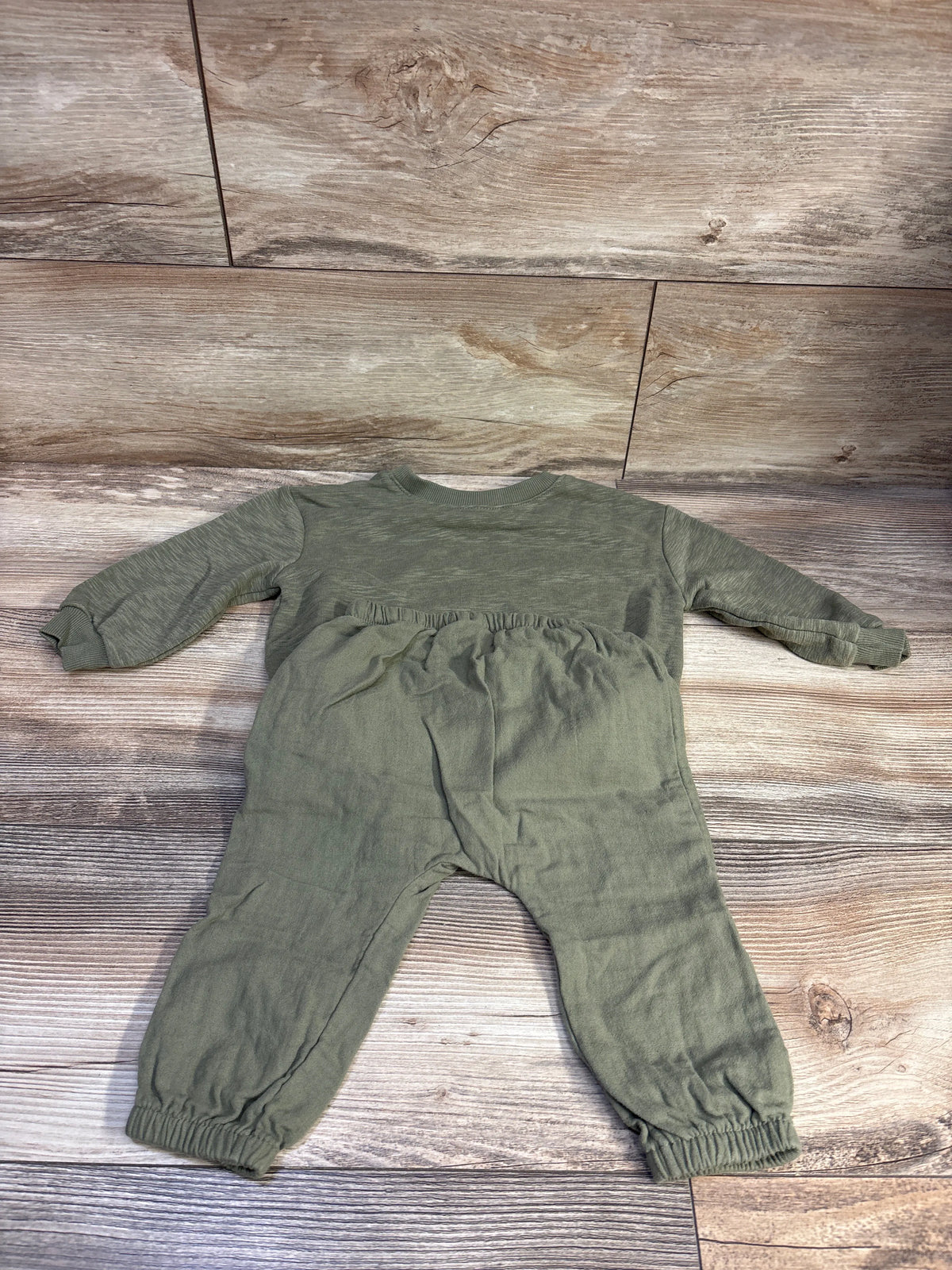Overhead view of Old Navy green 2-piece pullover and joggers set for ages 12 to 18 months with elastic cuffs and waistband