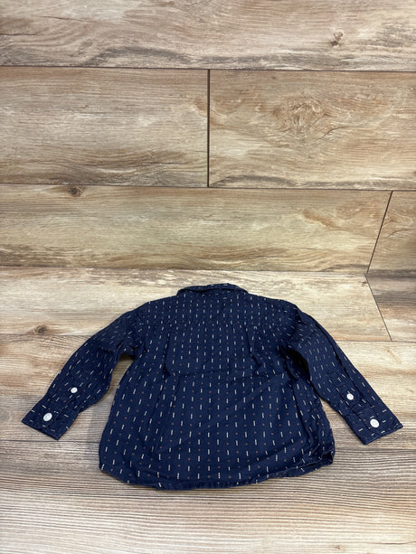 Back flat lay of Children’s Place navy button-up shirt showing long sleeves, dotted print and white cuff buttons on a light wood background