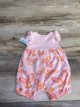 Front flat lay of Just One You sleeveless shortie romper with ribbed pink bodice, ruffle sleeves, and orange butterfly-print bottom on wood background
