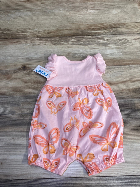 Front flat lay of Just One You sleeveless shortie romper with ribbed pink bodice, ruffle sleeves, and orange butterfly-print bottom on wood background