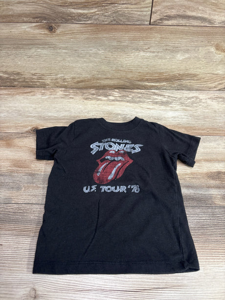 Front view of black Rolling Stones shirt in size 2T showcasing the tongue logo and U.S. Tour 78 graphic on a wood background