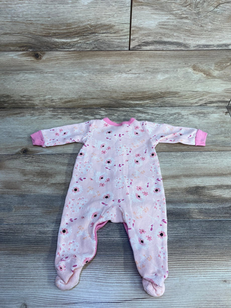 Flat lay of Little Beginnings waffle knit footed sleeper, pink floral print, size 3-6 months, on wood plank background