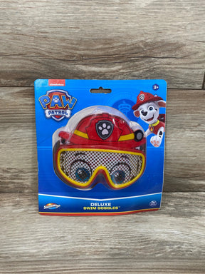 Front view of Paw Patrol Marshall swim goggles with red firefighter helmet and yellow-trimmed lenses in blue retail package