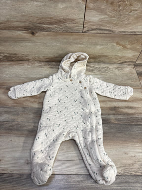 White quilted baby onesie with hood and button details, patterned with small gray dots, laid flat on wood floor