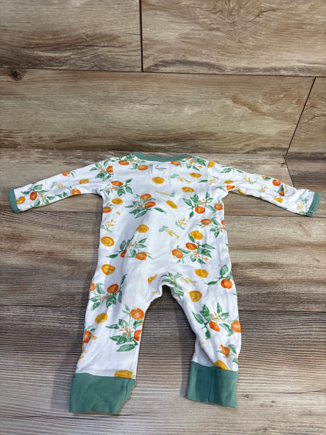 Flat lay of Burt’s Bees Baby organic sleeper in white, size 0 to 3 months, showcasing citrus print and green cuffs on a wood floor