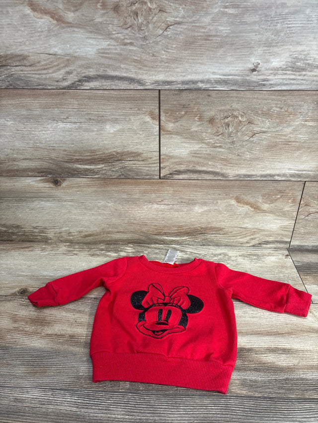 Red toddler sweatshirt featuring Minnie Mouse face on wooden floor background