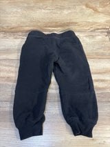 Black toddler jogger pants with elastic waistband on wooden background