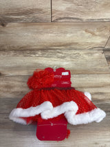 Red Santa-themed baby tutu set with white trim, gold dots, and matching headwrap on wood floor