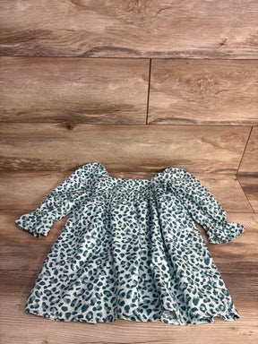 Long sleeve baby dress with blue and gray leopard print on wooden floor