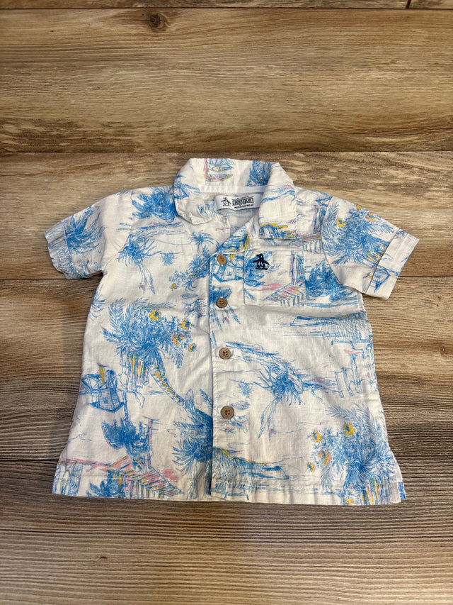 Toddler short sleeve button-up shirt with tropical blue palm print on wood background