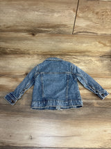 Children's denim jacket with long sleeves on a wood floor, gently used kids clothing