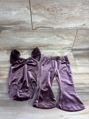 Purple velvet toddler outfit with ruffle sleeve top and flared pants on wood background