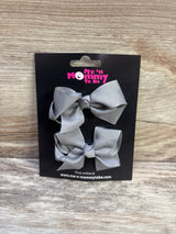 Front view of two grey grosgrain hair bows showcasing knotted centers on a black Me n Mommy To Be display card with wood background