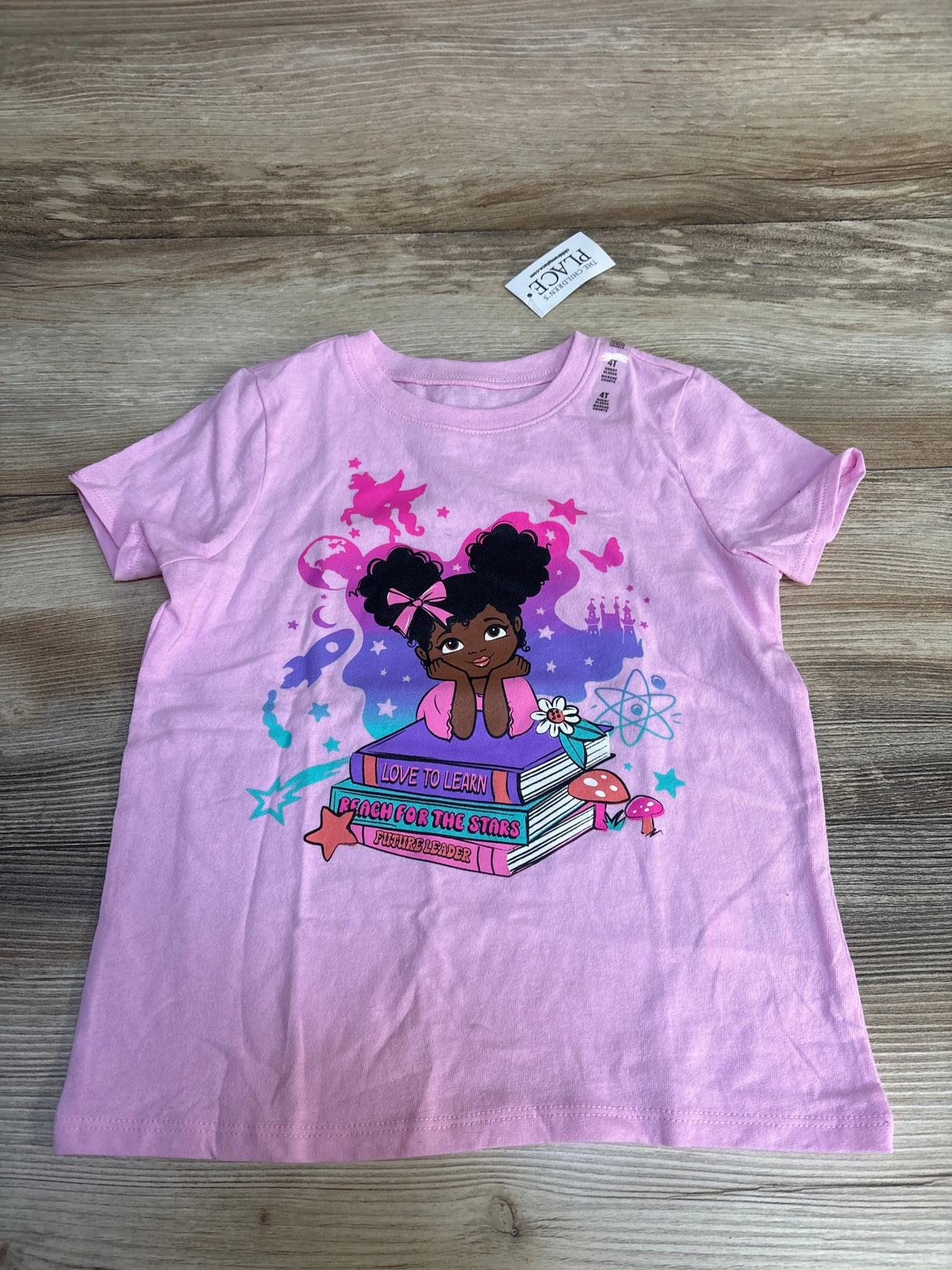 Pink kids t-shirt with girl reading books, stars, and 'Love to Learn' design