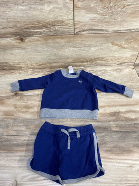 Blue and gray toddler sweatshirt and shorts set for kids, laid flat on wood floor.