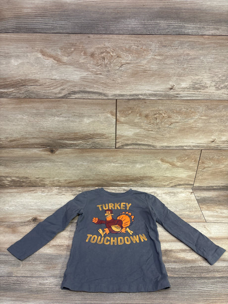 Front view of Carter’s Turkey Touchdown Shirt in grey, size 2T, showcasing long sleeves and turkey football graphic on wood plank background