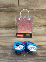 Front view of Marvel Ghost-Spider snap baby booties with pink and blue snaps and mask motif, clear Marvel packaging on wood