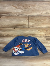 Blue long sleeve kids shirt with PAW Patrol characters and GAP logo, laid on wood floor