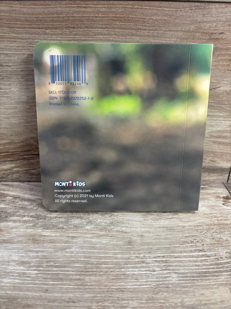 Back cover of Emotions Board Book showing Monti Kids logo, barcode, and publication details on a gray blurred design