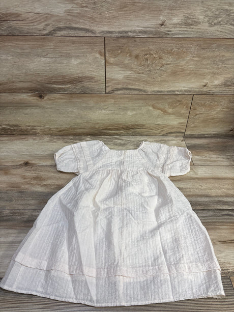 Front view of Zara crinkled muslin dress in ivory, showcasing puff sleeves, gathered waist, and tiered skirt on a wood floor
