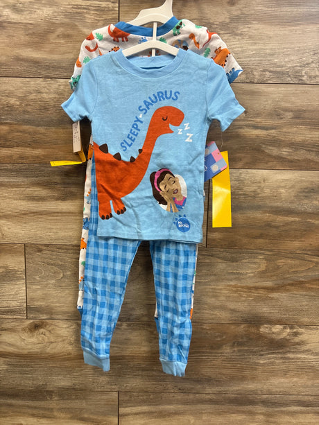 Front view of Ms Rachel toddler pajama set showcasing light blue Sleepy-saurus dinosaur tee and blue gingham pants on wooden background