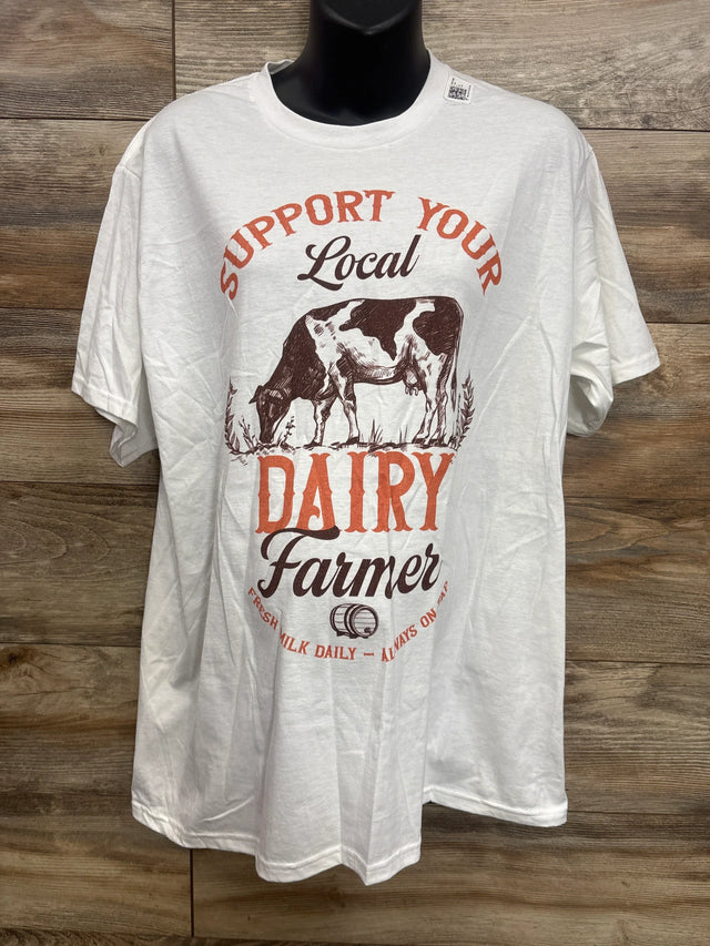 Front of white maternity T-shirt with 'Support Your Local Dairy Farmer' cow graphic and orange DAIRY text on wood backdrop