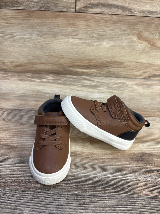 Front and side view of toddler brown faux-leather sneakers with white rubber soles and velcro strap on wood background