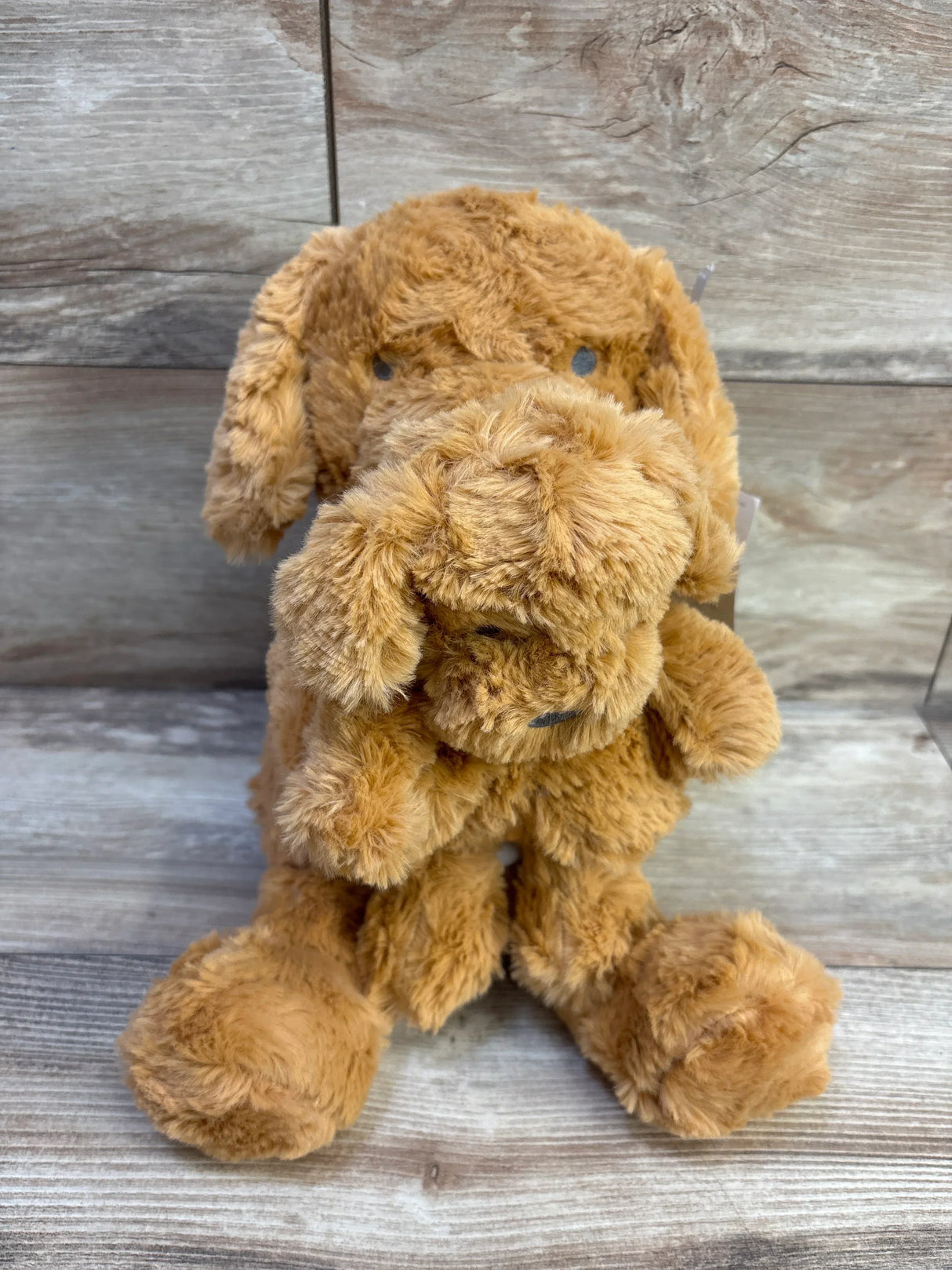 Front view of Cloud Island brown dog plush showcasing a mini matching plush puppy with wood plank backdrop