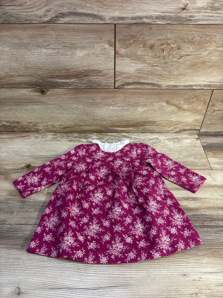 Flat-lay front of Janie & Jack long-sleeve quilted pink baby dress with white floral print and ruffled collar on wood
