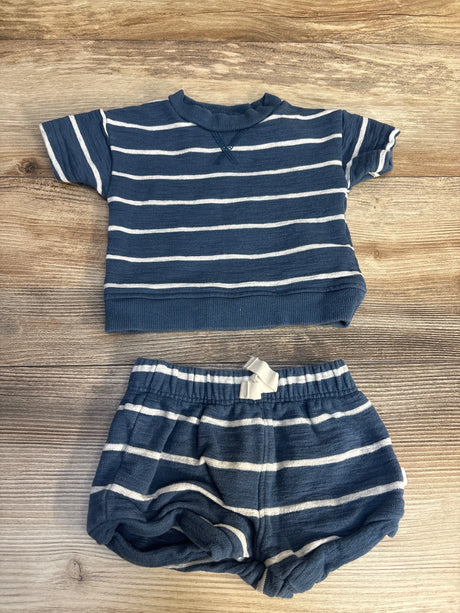 Blue and white striped baby outfit with short sleeve shirt and shorts on wooden background