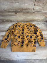 Kids mustard yellow sweatshirt with navy sports and champion graphics on wood background