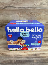Front view of Hello Bello Premium Diapers size 1 box showcasing 82 diapers and Dr Seuss Babies design on a wood background